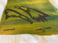 Close-up showing the hand painted stylized animal heads against green background with red dots and artist signature dated '09'.