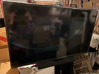 Front view of the Insignia flat screen TV showing the screen and base stand.