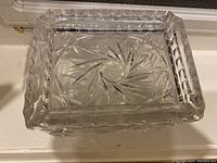 Top-down view showing hand-cut swirl star pattern inside crystal box