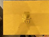 Yellow box with gold foil branding CC&T for coffee & tea