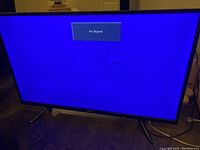 Front view of the RCA 42-inch LED TV turned on with 'No Signal' message displayed on screen