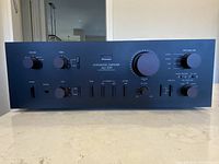 Full front view of amplifier showing layout of knobs and sliders