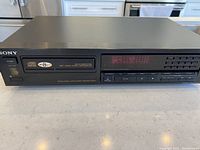 Front view of Sony CDP-690 CD player showing display, buttons, and disc tray with branding and digital audio logos.