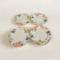 Four Mikasa Country Classics Fruit Panorama salad plates arranged showing the fruit pattern and scalloped edges.