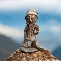 Front view of vintage pewter gnome figurine showing detailed face, hat, and clothing.