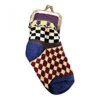 Front view of the vintage sock-shaped coin purse showing the intricate hand-knit design with checkerboard, diamond, and floral motifs and the brass clasp frame.