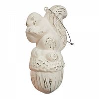 Front view of white vintage squirrel ornament on acorn with hanging cord attached