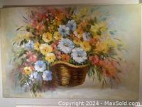 Photo of the still life oil painting showing a colorful floral arrangement in a basket on canvas, measuring approximately 24 x 36 inches.