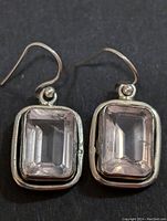 Front view of both silver earrings showcasing the rectangular rose quartz stones set in silver bezel frames.
