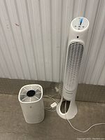 Full view of the Honeywell QuietSet tower fan and the compact air purifier unit both in white plastic.