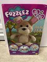 Front view of Fuzzeez craft kit box showing plush bunny and craft instructions graphics.