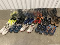 All 11 pairs of various kids shoes for children ages 1-2 years, mostly sneakers and athletic footwear in multiple colors