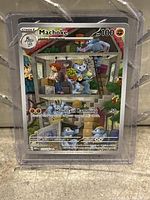 Clear view of Machoke Pokémon card encased in protective sleeve.
