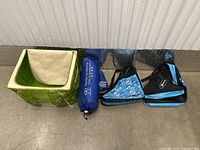 Photo showing the three smaller bags laid out next to the foldable travel laundry basket.