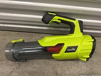 Side view of handheld Snap Fresh cordless leaf blower showing clear plastic nozzle, green and black body with ergonomic grip.