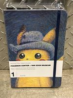 Front view of the sealed journal with Pikachu wearing a hat against Van Gogh style background and elastic band.