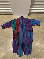 Full front view of the vintage bathrobe laid flat showing multicolor vertical stripe pattern and geometric designs.
