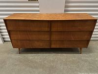 Front view of six-drawer teak dresser showing overall appearance and drawer configuration