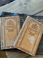 Photo of two vintage books titled The World's Famous Orations by William Jennings Bryan showing cover wear and stains