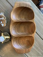 Overhead photo showing handcrafted Monkey Pod wood tray with three delicately curved compartments