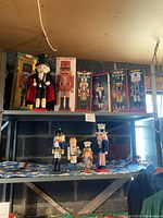 Full shelf with seven nutcrackers, four boxed and three unboxed, varied sizes and designs