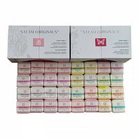 Closed view of two Steam Originals boxes with all 32 wrapped shower steamers arranged in front, displaying various pastel colors and blend numbers.