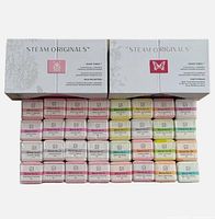 Two sealed Steam Originals boxes with 16 shower steamers each, different colors and blends visible.