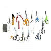 Top-down view of entire lot showing various scissors and cutting tools on white background