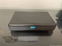 Closed black plastic CD storage case for the collection.