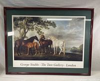 Full view of framed George Stubbs art print showing horses and tree with green and white double matting in wood frame.