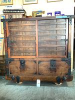 Front view showing two sliding doors, two bottom drawers, metal hardware