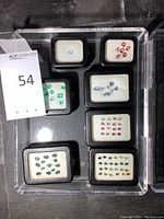 Acrylic tray containing eight smaller trays of various loose faceted gemstones