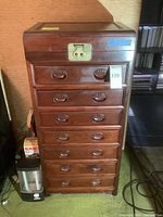 Front view of full-height jewelry armoire with drawers and top compartment