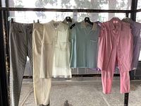 Full rack of pastel and neutral garments on metal pipe rack