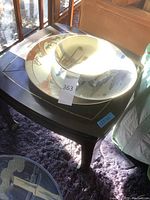 Full view of wooden table with mother of pearl inlay and stacked ceramic bowls