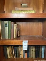 Full view of two shelves showing multiple antique books
