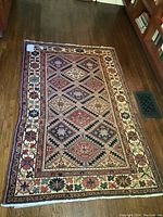 Full view of rectangular area rug on hardwood floor
