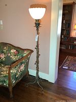 Full height shot of lamp next to upholstered sofa, showing overall design and scale