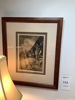 Full frontal view of etched print in carved wood frame