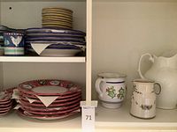 Overall shelf view with stacked plates and pitchers