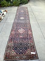 Full-length view of runner rug laid out on pavement