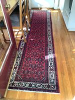 Full-length view of red runner laid in hallway