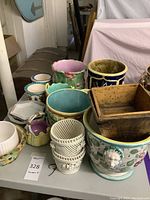 Multiple ceramic planters and small baskets displayed on table