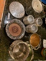 Overview of lot showing ice bucket, glass jar, coaster stacks, engraved platter, serving bowl