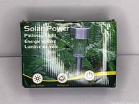 Box front showing the product name 'Solar Power Pathway Light' with icons for solar charge, waterproof, and on/off functionality.