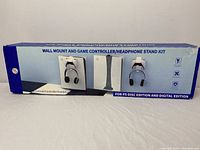 Box front showing image of the wall mount and desktop stand kit for PS5 controllers, headphones; emphasizes organized gaming setup.