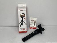 Full view of Mobifoto Mobipod Pro50 tripod alongside its Bluetooth remote in original packaging, showing branding and item condition.