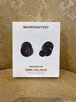 Front view of the closed white retail box showing the product image and Monster branding with model name 'Achieve 300 Airlinks'.