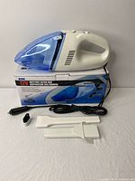 iLink 12V Wet/Dry Ultra Vac handheld vacuum and attachments displayed on a flat surface with product box