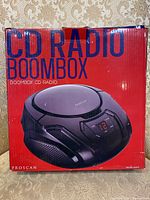 Front photo of the original box with Proscan CD radio boombox image and product title